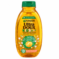 Garnier Ultra Doux Kids Apricot shampoo and detangler in its amber bottle with green cap on white background